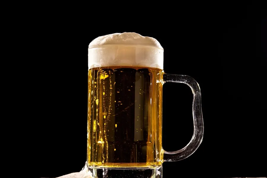 A frothy mug of beer, the drink gout guidance most consistently recommends limiting