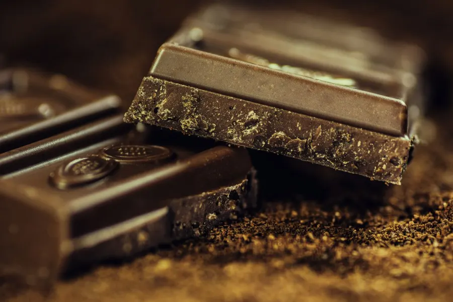 Stacked squares of dark chocolate dusted with cocoa powder